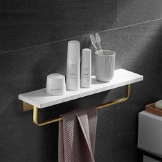 a bathroom shelf with three items on it