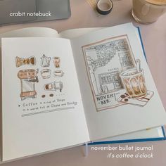 an open book with drawings on it next to a cup of coffee and a laptop