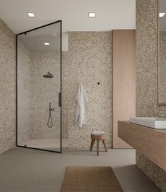 a bathroom with a sink, mirror and shower stall in it's center area