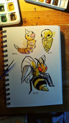 an open notebook with drawings of bees and honeybees on it next to some watercolor paints