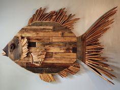 a fish made out of wood sticks on a wall