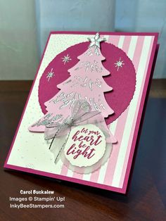 a christmas card with a pink and white tree on the front, which reads i am going to light it