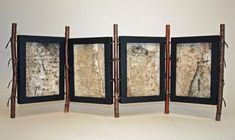 four panel screen with wood and paint on the front, two are open to reveal an image