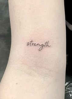 the word strength written in cursive font on the left side of the arm