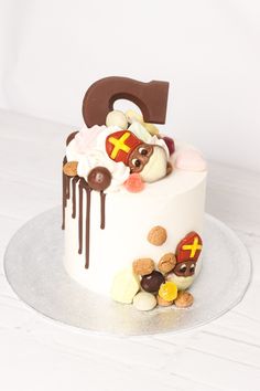 a white cake topped with lots of different types of candies and chocolate on top