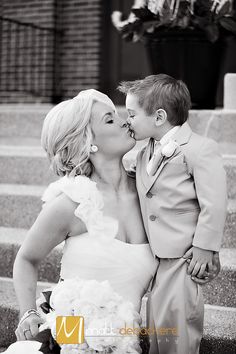 a bride and groom kissing on the steps