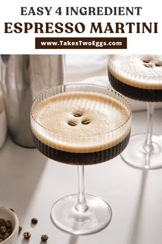 two martinis sitting on top of a table with coffee beans