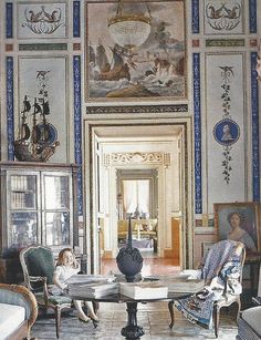 two children sitting at a table in an ornately decorated room