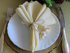 a white plate topped with a napkin and silverware