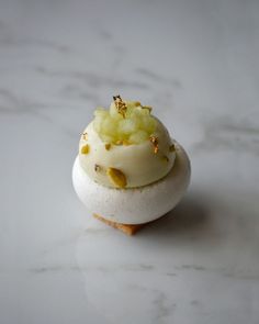 a close up of a pastry on a white counter top with gold sprinkles