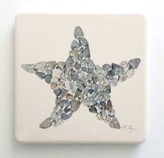 a starfish made out of rocks on a white wall