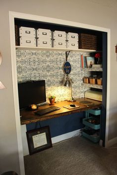 a desk with a computer on top of it in front of a book shelf filled with books