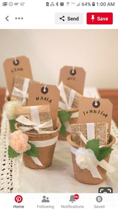 there are small baskets with tags on them and some flowers in the bottom one is made out of paper