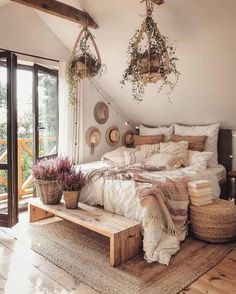 a bed sitting in a bedroom next to a wooden table with baskets on top of it