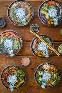 a table topped with bowls filled with different types of salads and condiments