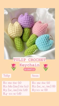 four crocheted turtle keychains sitting on top of a white cloth covered table