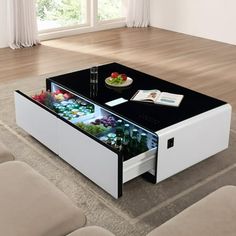 a coffee table with an open drawer underneath it on top of a carpeted floor