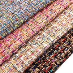 several pieces of woven fabric are stacked on top of each other in different colors and patterns