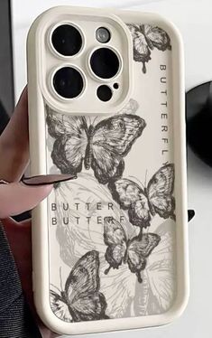 a person holding up a phone case with butterflies on it