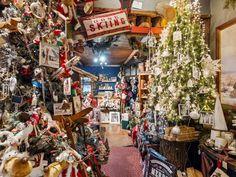 a store with christmas trees and other holiday decorations