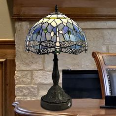 a table lamp sitting on top of a wooden desk