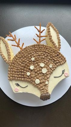 a white plate topped with a cake shaped like a deer