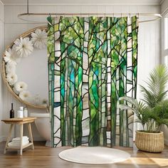 a bathroom with a shower curtain that has stained glass trees in the center and flowers on the side