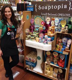 a woman standing in front of a store display