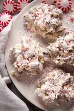 a white plate topped with cookies covered in candy canes and marshmallows