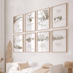 a bedroom with white walls and pictures on the wall above the bed in front of it