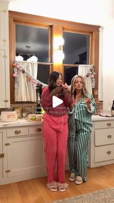 two women standing in front of a kitchen counter