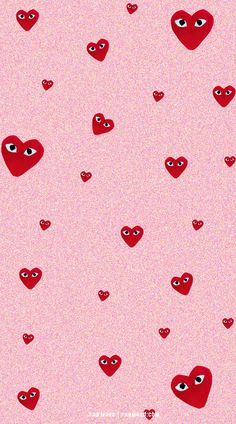 red hearts with eyes on a pink background