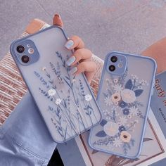 two phone cases with flowers on them, one is blue and the other is white