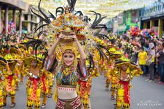 a group of women in colorful costumes marching down the street