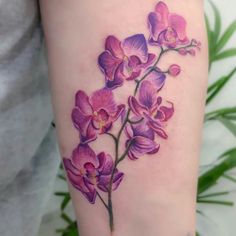 a close up of a person's leg with flowers on it