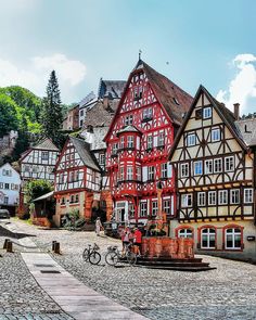 a cobblestone street lined with old buildings and bicycles parked in front of them