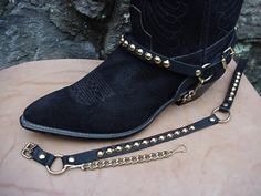 Metal for Your Bootsl!  Round Studs (Nailheads) on sturdy Genuine Topgrain Leather Straps, 13 studs on front and 7 on backstrap. Studs are Brass base, Gold color finish; will not rust. Steel underchain for tight fit on any pair of western or biker boots. Studs are about 5/16, or 8MM. Color: Black with Gold Colored Hardware. Brand New! NOT Made in China! Proudly Handcrafted in the USA by me in Nashville, Tennessee. My 20+ years of manufacturing experience assures you Top Quality Merchandi... Leather Boots With Chain For Fall, Ankle-high Boots With Metal Feet For Winter, Black Boots With Chains, Black Boots Chains, Black Boots Gold Chain, Boot Chains, Boot Bracelet, Boot Bling, Boot Straps