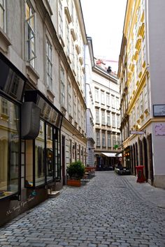 a cobblestone street lined with tall buildings