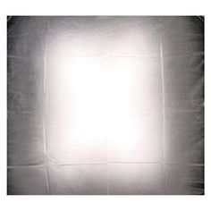 a light that is on in the middle of a white sheeted wall with a black background