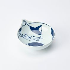 a white and blue bowl with a cat design on it