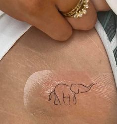 an elephant tattoo on the back of a woman's stomach is seen in this undrecognized image