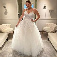 a woman in a white wedding dress posing for the camera