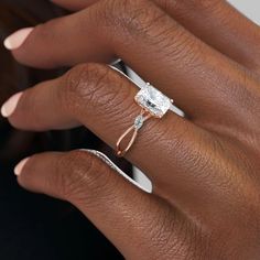 a woman's hand with a ring on her finger and an engagement band around her wrist