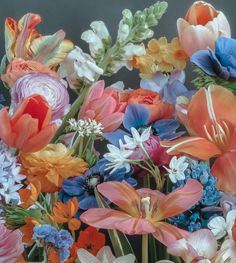 an arrangement of colorful flowers in a vase