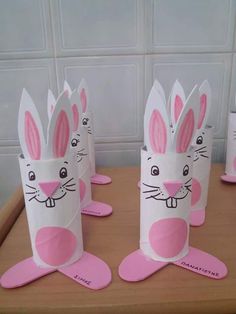 some paper cups with bunny ears on them