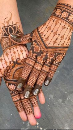 two hands with henna designs on them