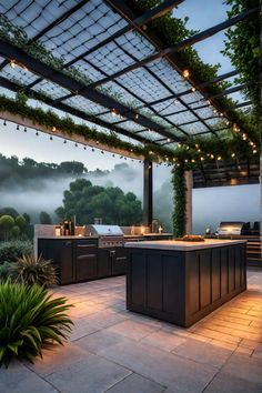 an outdoor kitchen is lit up with string lights and surrounded by greenery on the roof