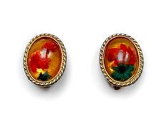 | d e s c r i p t i o n | Cute as a button 1960s clip on earrings.  these earrings, framed in a gold tone frame, feature vibrant red and blue-green dried flowers. They have an amber-gold reflective background.  The flowers are set in and clear plastic which has an convex surface.  No makers mark. | m e a s u r e m e n t s | Height: 7.5/8" Width: 6/8" | c o n d i t i o n | Good vintage condition. Gold tone has worn off the frame.  No cracks or chips. One darkish scuff on surface of one earring. P Reflective Background, Cute As A Button, Clear Plastic, Vibrant Red, Earrings Gold, Makers Mark, Gold Frame, Clip On, Dried Flowers