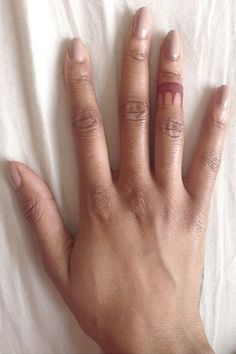 a woman's hand with tattoos on it