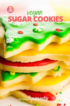 a stack of vegan sugar cookies with green, yellow and red frosting on top